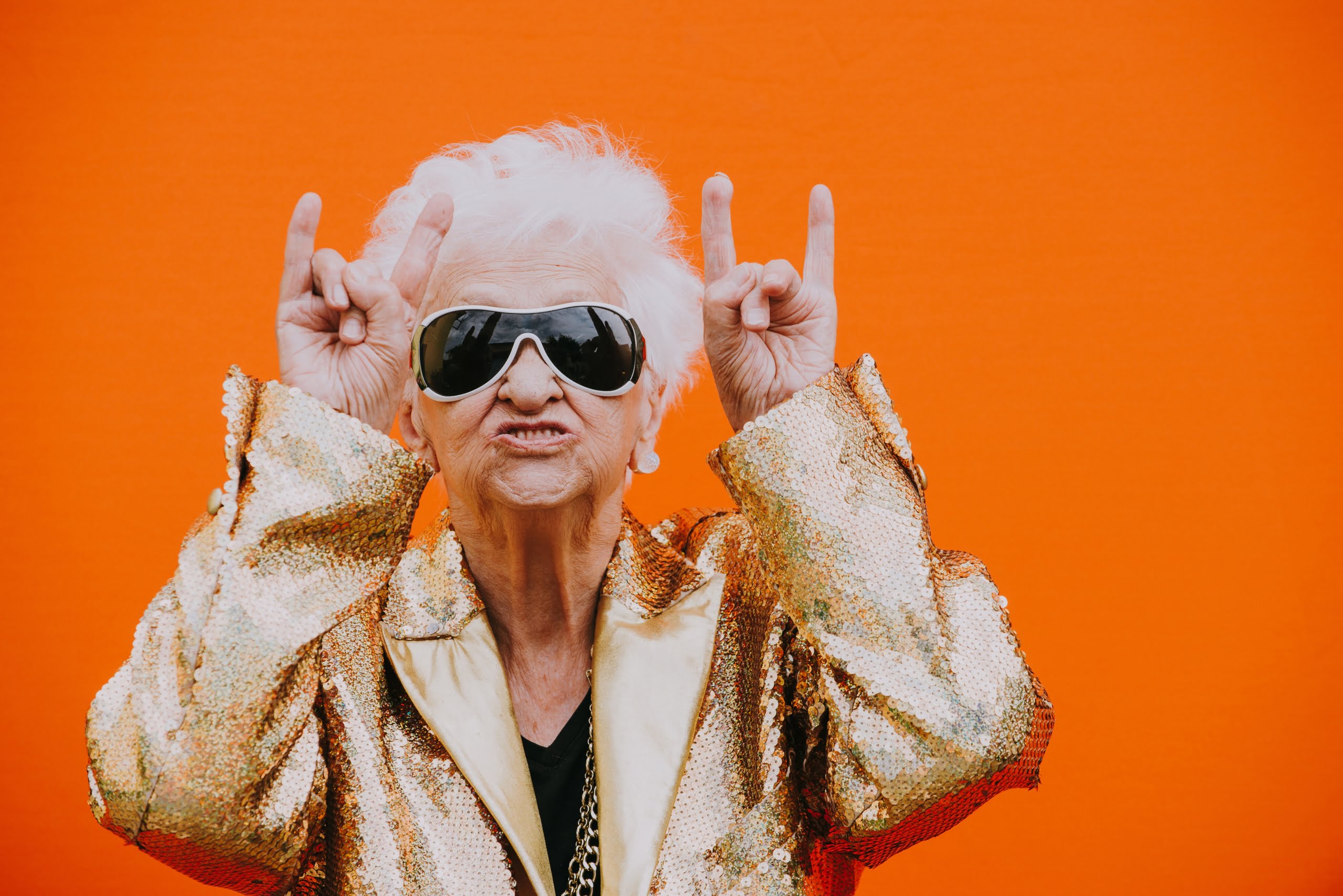 rock and roll grandma wearing sunglasses, gold jacket