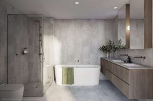 grey bathroom tile, white bathtub, 2 sinks and 2 mirrors