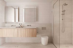 cream rectangle tile bathroom, light wood cabinets with 2 sinks