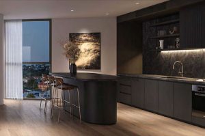 Dark Kitchen cabinets, black countertops, 3 gold and brown bar stool