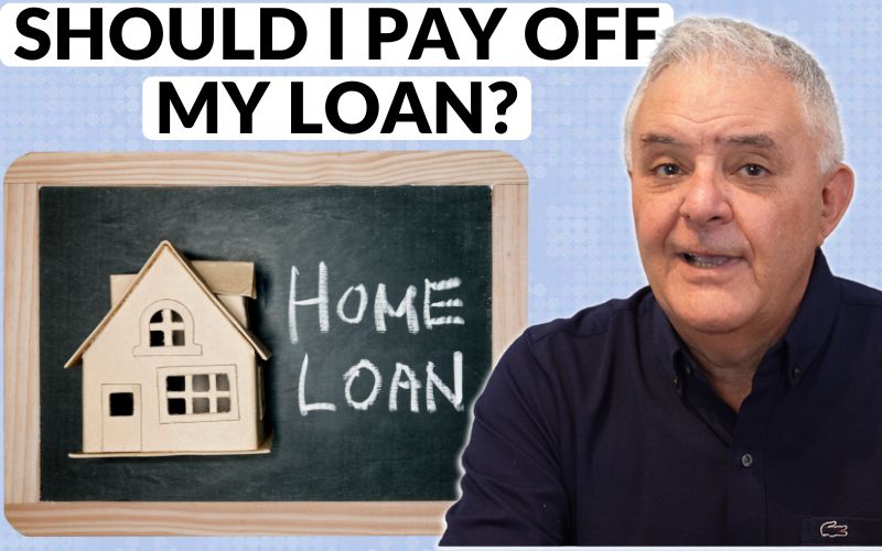 Andrew Unterweger next to a blackboard that says home loan